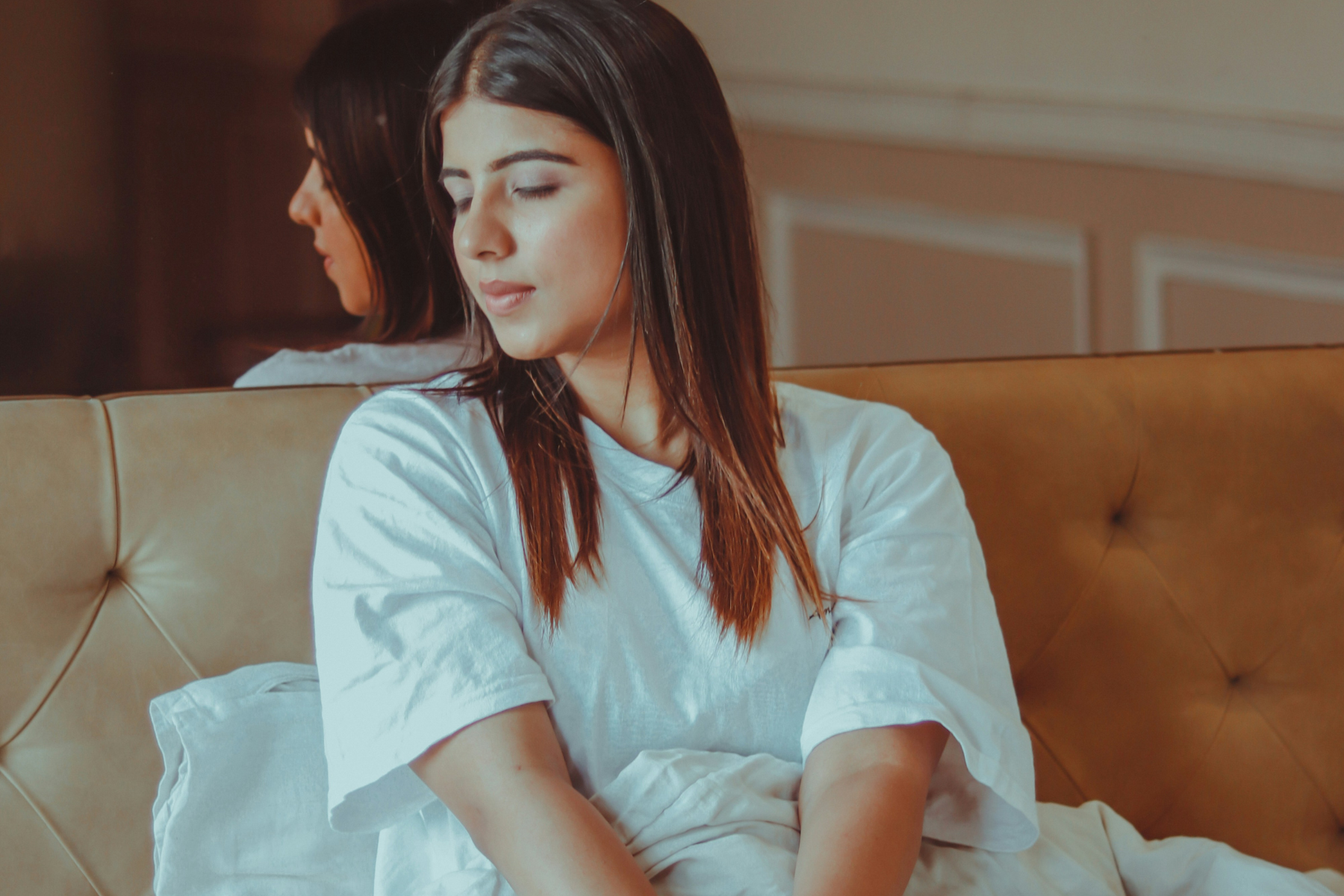 Young woman sitting quietly on a sofa